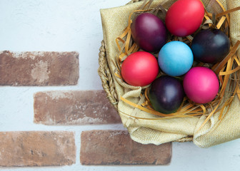 Easter composition with color  eggs on  wooden background, space for text.