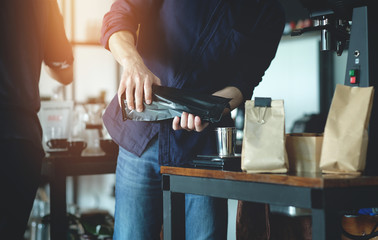 Barista man making coffee in cafe with vintage light tone 