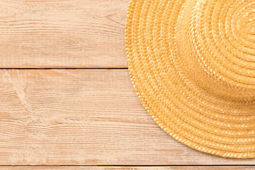 Fototapeta na wymiar Straw hat on wooden table. The concept of summer.