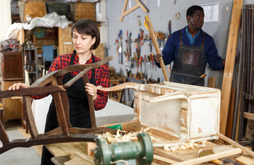 Кestorer inspecting antique armchair