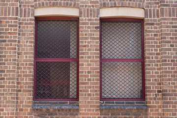 Red window on a brick wall.