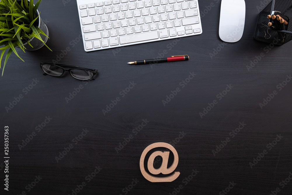 Poster flat lay of top view modern black wood desk work table with computer laptop and stationary in home o