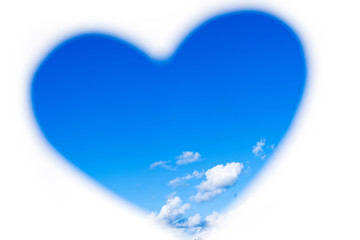 Hands holding paper heart on blue sky - concept of environmentally friendly.