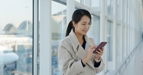 Woman use of mobile phone in the airport