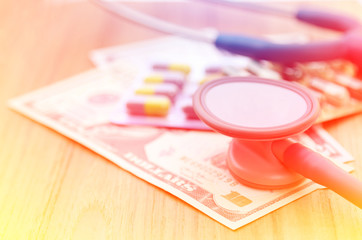 Stethoscope with medicine and dollar money for business concept 