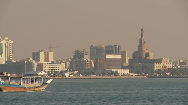 WS Dhow sailing in Doha Bay, city skyline  in background / Doha, Qatar