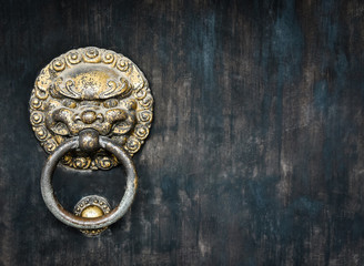 Obraz na płótnie Canvas Chinese Style ancient door metal knocker lion handle , mottled and brass wooden door knocker.