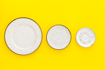Mockup with plates. Empty ceramic plates on yellow background top view copy space