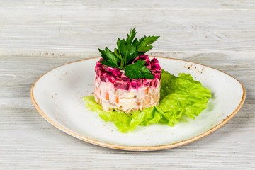 layered salad with herring, beets, carrots, onions, potatoes and eggs