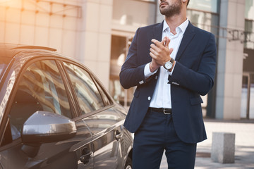 Young businessman near new car wating for meeting