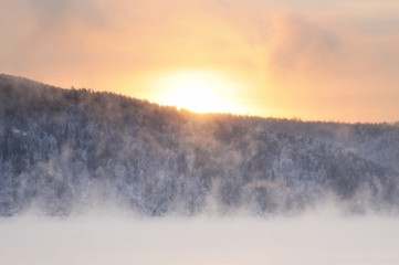 Foggy sunrise on the Yenisei river in winter near Krasnoyarsk in Siberia, Russia