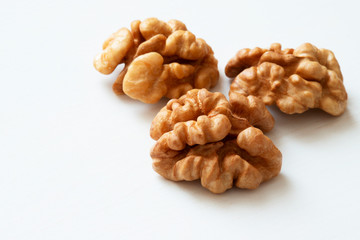 A peeled walnut on a white wooden table with copy space