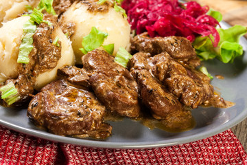 Pork tenderloin in mushroom sauce with boiled potatoes and salad..Pork tenderloin in mushroom sauce with boiled potatoes and salad..Pork tenderloin in mushroom sauce..