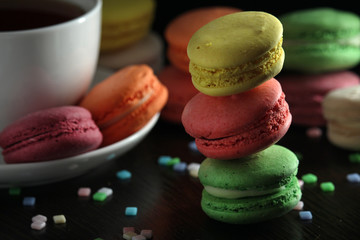 Bright macaroons against dark background