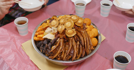 Traditional Chinese family eating big bowl feast together at home