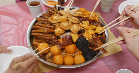 Traditional Chinese family eating big bowl feast together at home