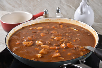 Beef stew simmering in a pan