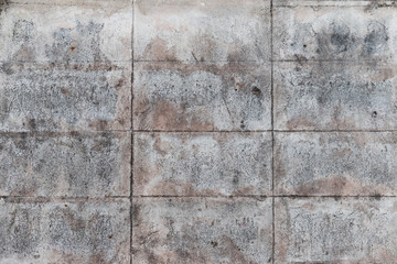 The old gray concrete block wall for background and texture which got some rusty color. The rectangle pattern.