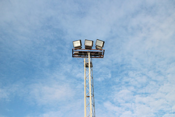 Pillar spotlights football field in the background sky cloud