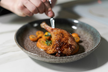 Chef is decorating a dish - fried duck leg