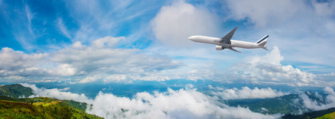 Panorama Photo An airplane flying in the blue sky. passenger plane flies highly over clouds of...
