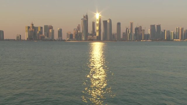 WS Financial district skyline seen across Doha Bay at sunset / Doha, Qatar