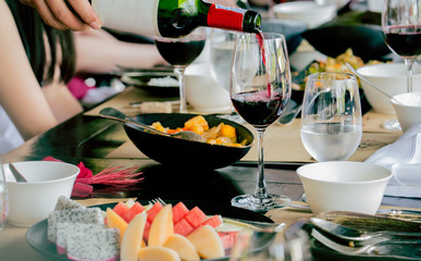 waiter serving red wine in a restaurant