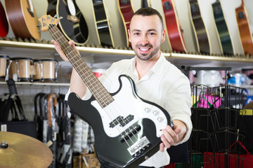 Fototapeta premium male buying new guitar