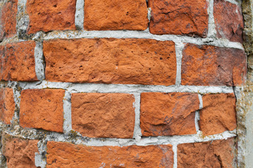 An oil column of red brick in an abandoned manor house. Close-up.