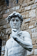 statue of Michelangelo's David in Florence in front of Palazzo Vecchio