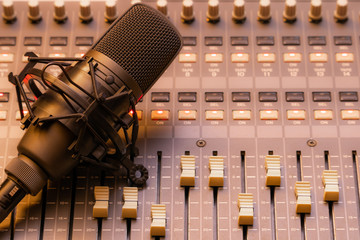 condenser microphone on sound mixing console. recording, broadcasting concept