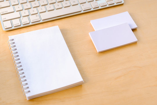A notebook and business cards on the desktop