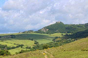 Fototapeta na wymiar Panorama of the central Italy green hills under cloudy sky.