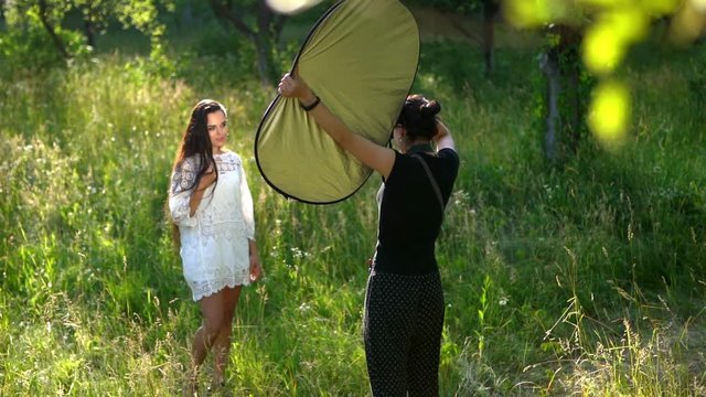 Lovely girl poses for the photographer in the park
