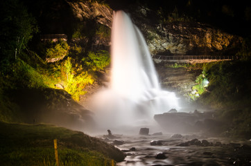 Beautiful waterfall Steinsdalsfossen in Norway shining lit up in the night