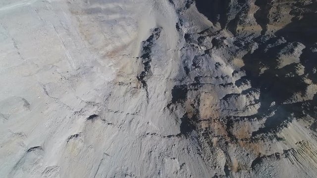 Aerial view of opencast mining quarry with lots of machinery at work - view from above.