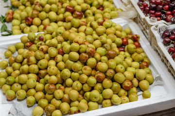 Green sour plums and cherries