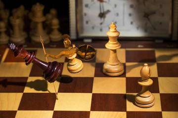 A pawn in the form of a gladiator warrior attacks the king. Shot in motion. Flying figures.