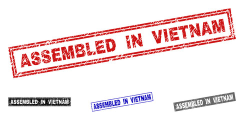 Grunge ASSEMBLED IN VIETNAM rectangle stamp seals isolated on a white background. Rectangular seals with distress texture in red, blue, black and grey colors.
