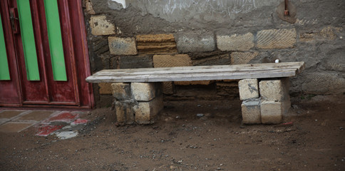 Wooden bench  in front of the house.