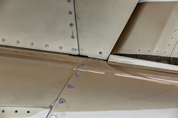 Aircraft body panels detail with golden plates