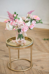 Wedding decoration of flowers. Beautiful bouquet on a stand. Classic interior. Vertical orientation