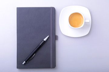 office table with notebook, computer keyboard,, cup of coffee, tablet pc. copy space.