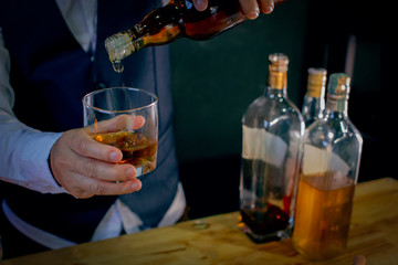 bartender pouring beer in glass