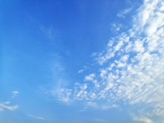 Naklejka na ściany i meble Blue sky with white, soft clouds.The sky is clear.