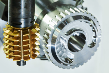 cogwheel milling process. Industrial CNC metal machining by hobbing cutter mill