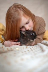 Red-haired girl with a rabbit