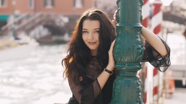 Travel tourist woman on pier against beautiful view on venetian chanal in Venice, Italy.