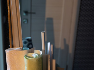 Rolls of wallpaper on the background of a white door in the apartment