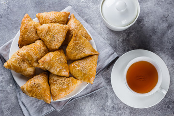Plate with delicious samosas samsa with meat on gray background, top view. Uzbek food